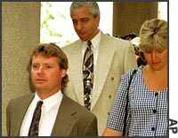 Scott Hornoff (left) with his wife, Rhonda, and his attorney