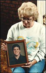 Gloria Paxton holding a photo of her son 