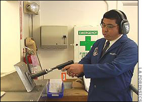 Rich Maruoka test fires a gun.