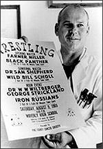 Sam Sheppard holds up poster for his wrestling match (CORBIS)