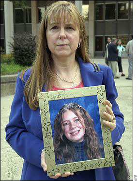 Long's mother holds a photo of her daughter