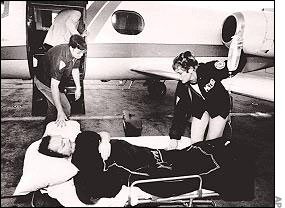 A wounded Flynt is carried away after the shooting