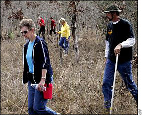 Volunteers search the area around the Lunsford home and beyond