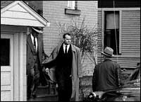 Sheppard led away, handcuffed to a police officer (CORBIS)