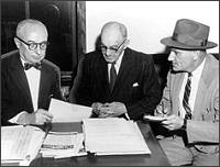 Sheppard led away, handcuffed to a police officer (CORBIS)