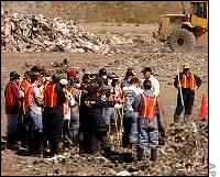 Police and volunteers search landfill