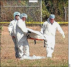 Coroners move Carlie's body.